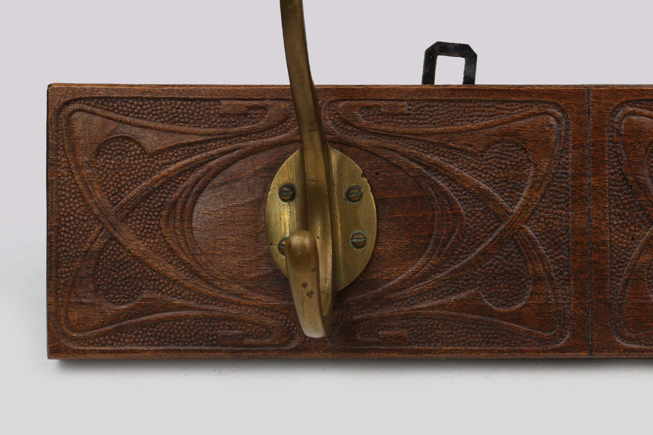 Art Nouveau wall coat rack in carved wood with brass, France ca. 1910thumbnail